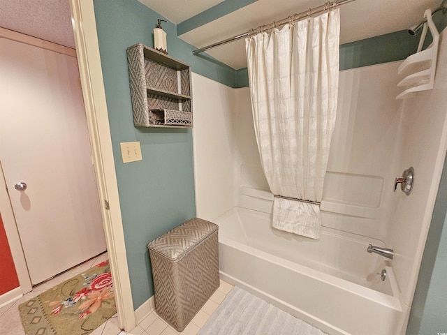 bathroom featuring tile flooring, shower / tub combo, and a textured ceiling