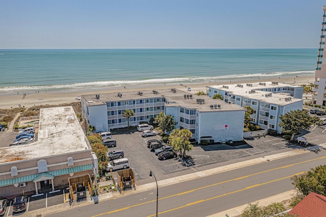 bird's eye view featuring a water view and a beach view