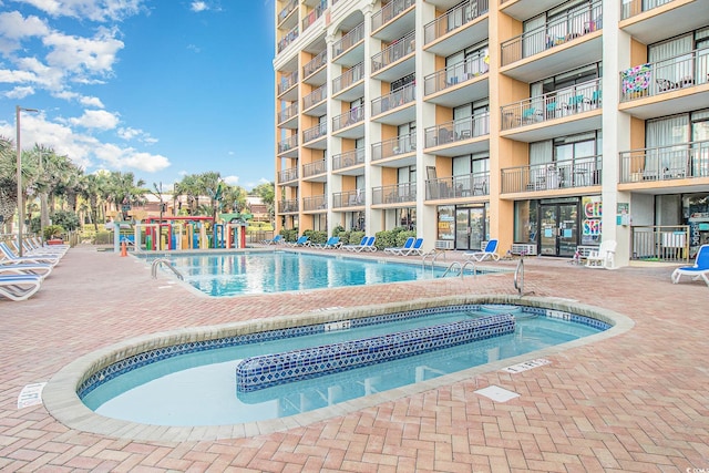 view of pool featuring a hot tub