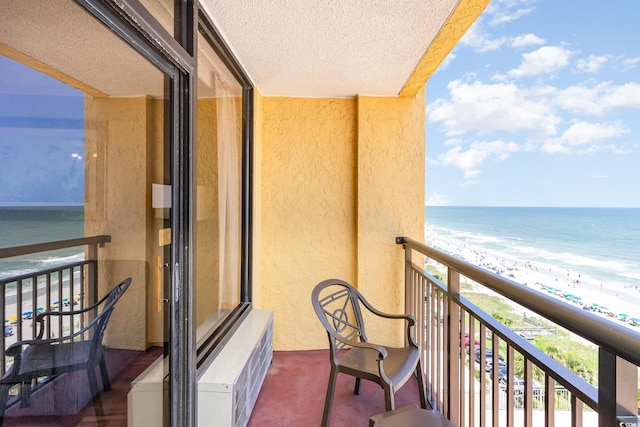 balcony featuring a water view and a view of the beach