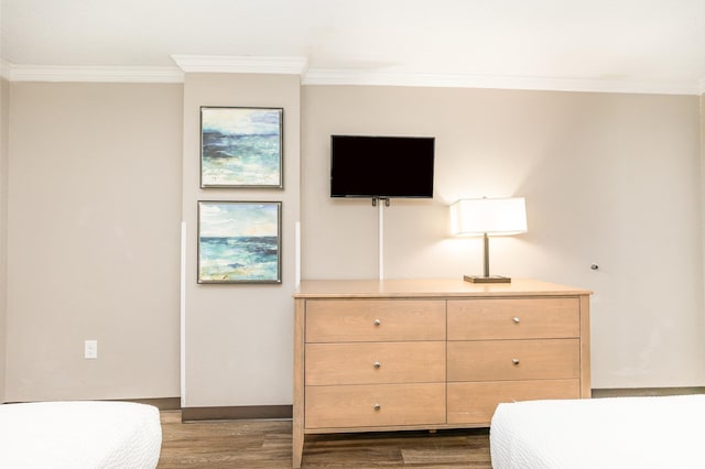 bedroom with dark hardwood / wood-style flooring and crown molding