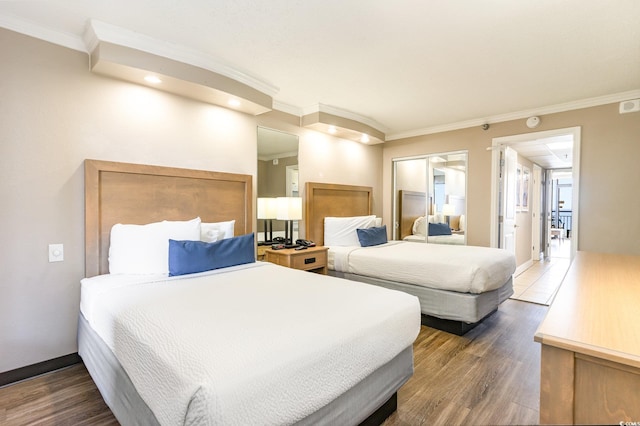 bedroom featuring a closet, crown molding, and dark hardwood / wood-style flooring