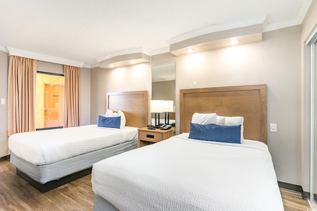 bedroom featuring hardwood / wood-style flooring and crown molding