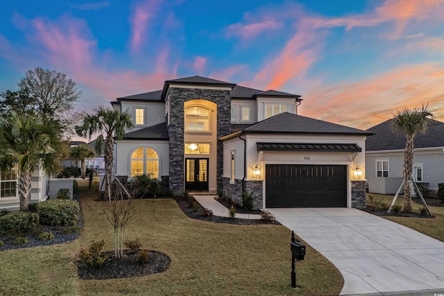 view of front of home with a yard and a garage