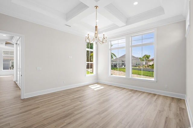 unfurnished room featuring an inviting chandelier, ornamental molding, a healthy amount of sunlight, and light hardwood / wood-style flooring