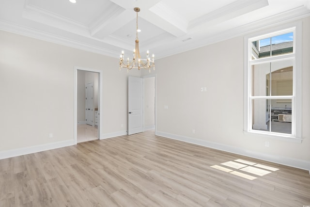 spare room with an inviting chandelier, crown molding, light hardwood / wood-style floors, and coffered ceiling