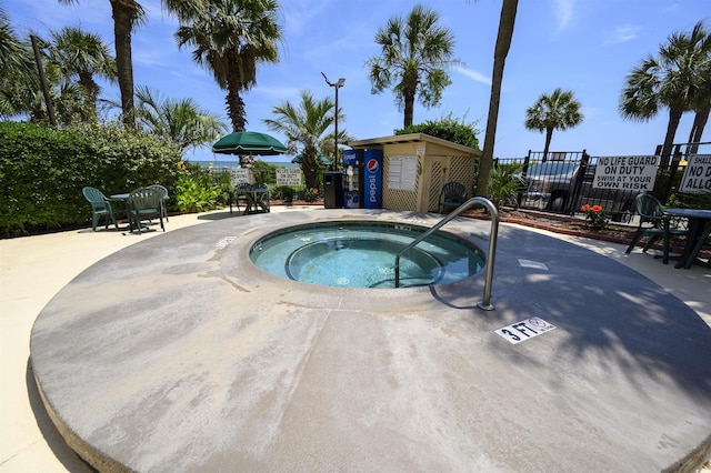 view of swimming pool with a community hot tub and a storage unit