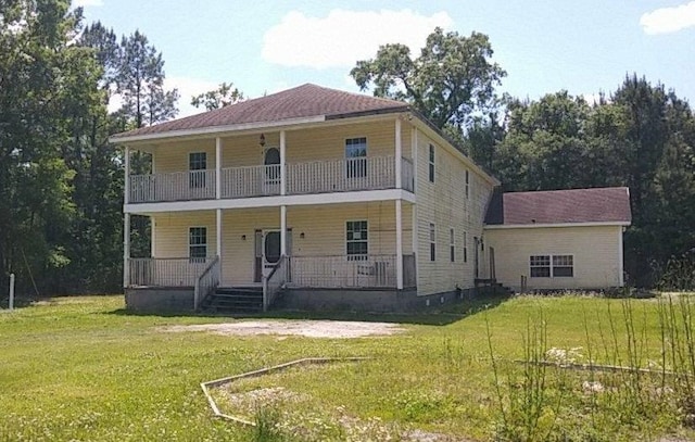 view of front of property with covered porch and a front yard