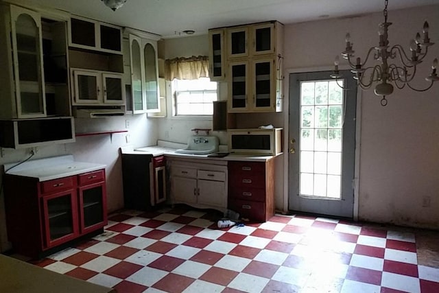 kitchen featuring plenty of natural light and a notable chandelier