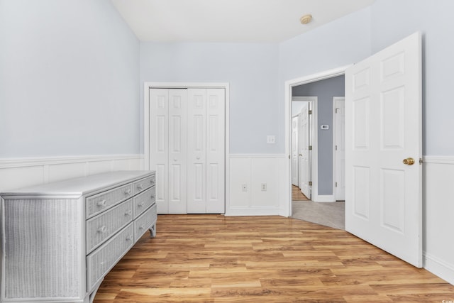 unfurnished bedroom with light hardwood / wood-style floors and a closet