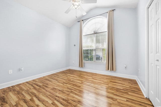 unfurnished room featuring ceiling fan, lofted ceiling, and light hardwood / wood-style flooring