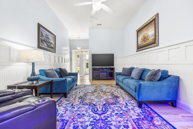 living room featuring ceiling fan, french doors, and wood-type flooring