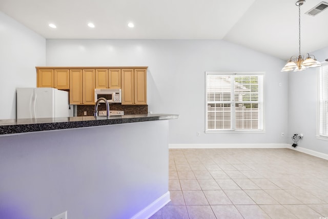 kitchen with backsplash, a chandelier, lofted ceiling, white appliances, and light tile patterned flooring