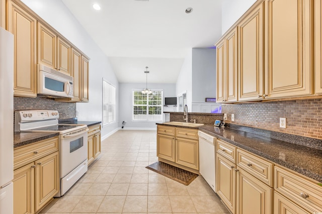 kitchen with white appliances, sink, hanging light fixtures, vaulted ceiling, and light tile patterned floors