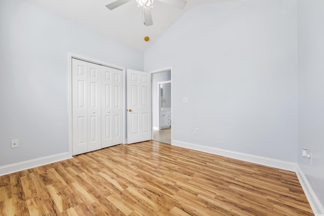 unfurnished bedroom featuring ceiling fan, a closet, high vaulted ceiling, and light hardwood / wood-style floors