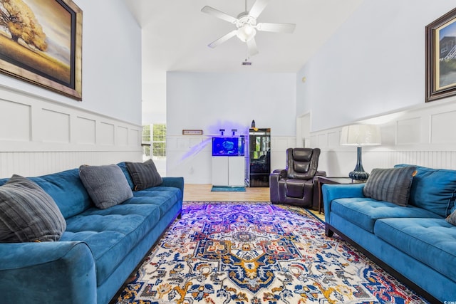 living room featuring ceiling fan and hardwood / wood-style floors