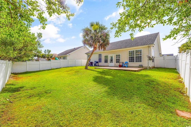 rear view of property featuring a yard and a patio