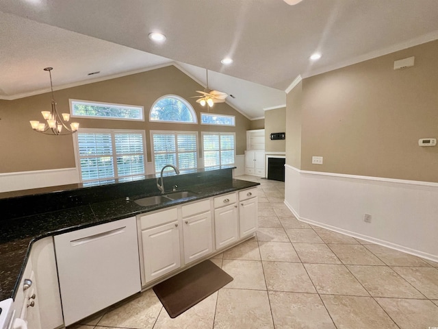 kitchen with sink, dishwasher, white cabinetry, ceiling fan with notable chandelier, and dark stone counters