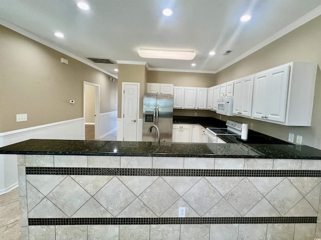 kitchen featuring sink, white cabinetry, ornamental molding, kitchen peninsula, and white appliances