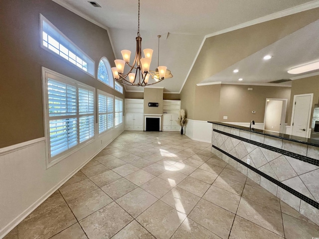 unfurnished living room featuring crown molding, light tile patterned floors, a notable chandelier, and high vaulted ceiling