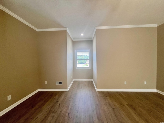 empty room featuring hardwood / wood-style flooring and crown molding