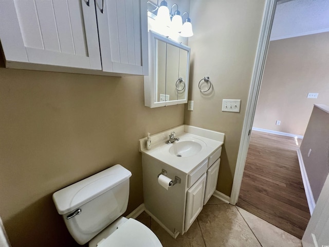 bathroom with vanity, toilet, and tile patterned flooring