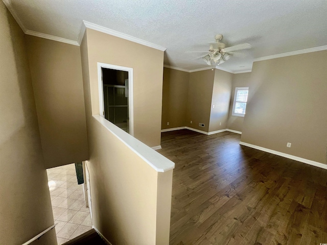 unfurnished room with crown molding, hardwood / wood-style floors, a textured ceiling, and ceiling fan