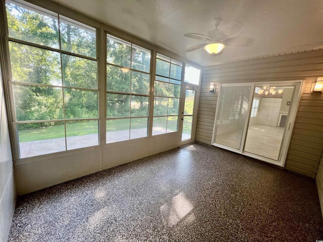 unfurnished sunroom with ceiling fan