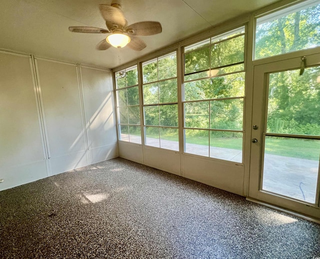 unfurnished sunroom with ceiling fan