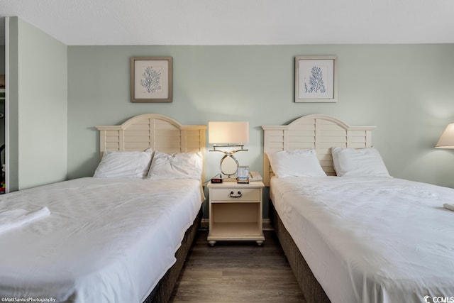 bedroom with dark wood-type flooring