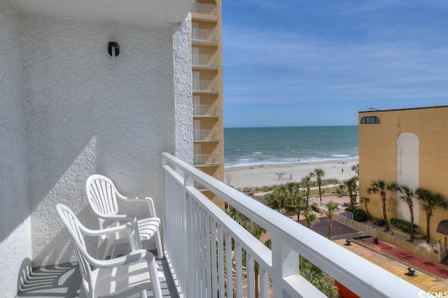 balcony featuring a water view and a view of the beach