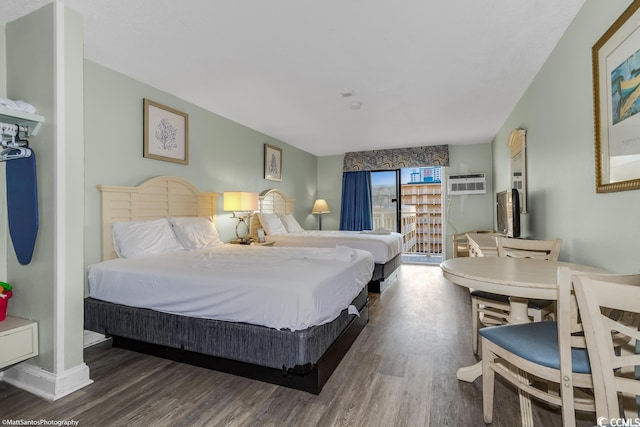 bedroom featuring dark hardwood / wood-style floors and a wall mounted air conditioner