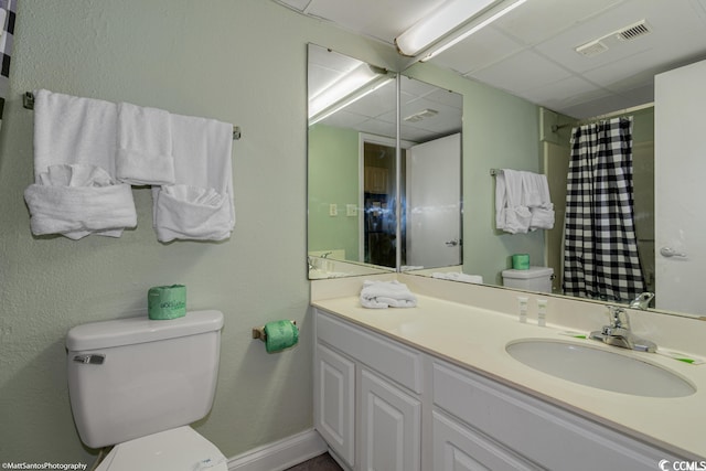 bathroom with toilet, vanity, and a shower with curtain