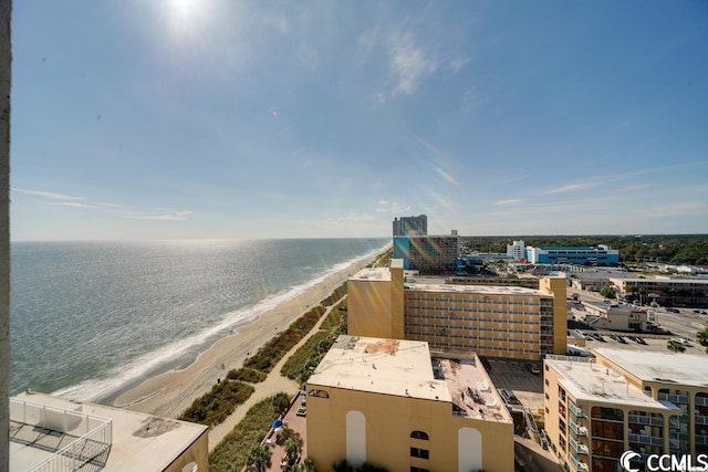 drone / aerial view featuring a water view and a view of the beach