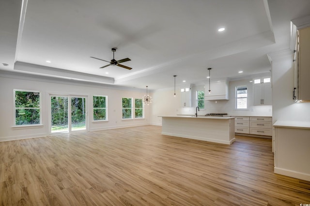 205 Brush Ct, Little River, SC 29566 - unfurnished living room featuring a raised ceiling, ornamental molding, ceiling fan, light wood finished floors, and recessed lighting
