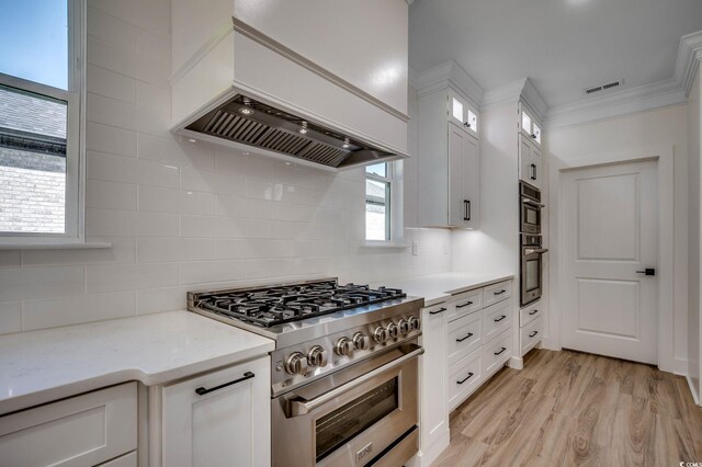 205 Brush Ct, Little River, SC 29566 - kitchen featuring high end stove, custom exhaust hood, white cabinetry, glass insert cabinets, and decorative backsplash