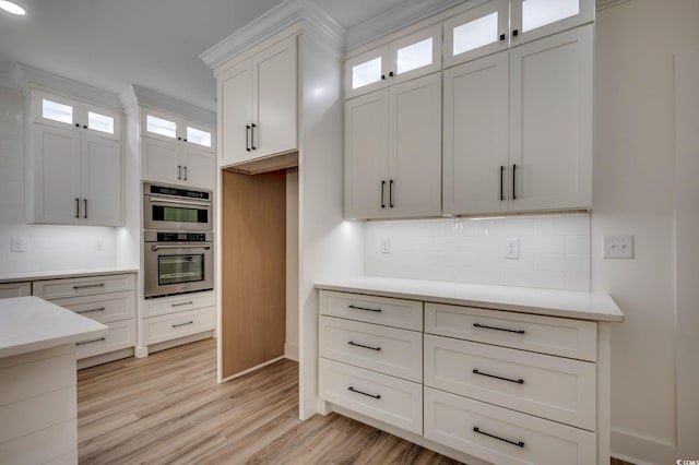 205 Brush Ct, Little River, SC 29566 - kitchen featuring backsplash, double oven, light countertops, white cabinetry, and light wood-style flooring