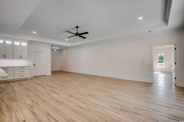 205 Brush Ct, Little River, SC 29566 - unfurnished living room with a tray ceiling, crown molding, ceiling fan, light wood-style flooring, and recessed lighting