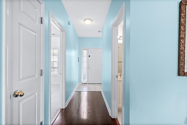 hallway with a textured ceiling and dark hardwood / wood-style flooring