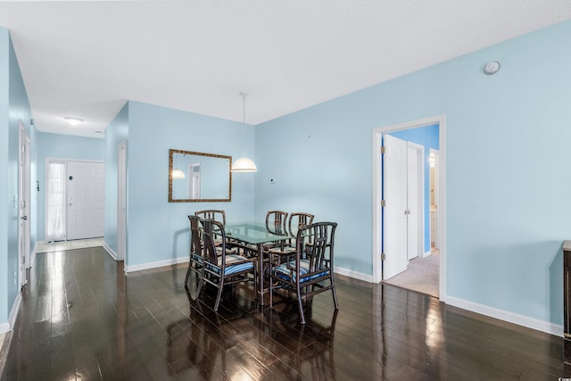 dining space featuring dark wood-type flooring