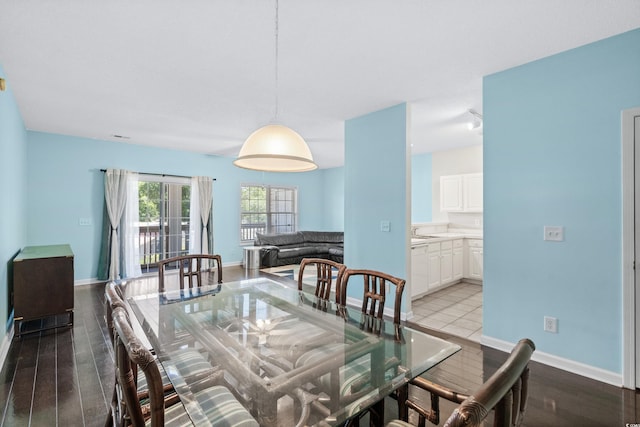 dining area featuring wood-type flooring and sink