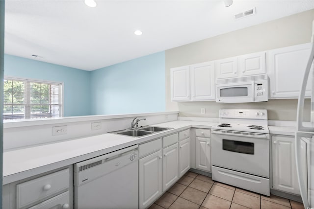 kitchen with light tile patterned floors, white appliances, white cabinetry, and sink