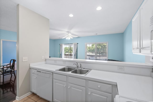 kitchen with dishwasher, white cabinetry, kitchen peninsula, and sink