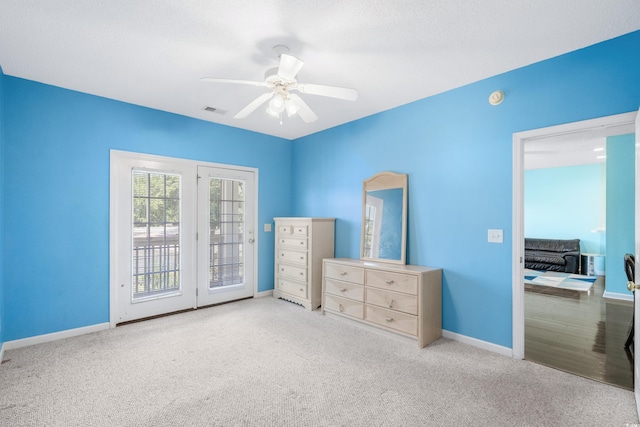 unfurnished bedroom with access to exterior, light carpet, and ceiling fan