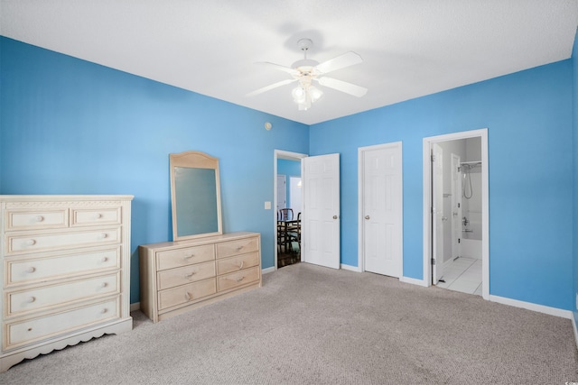 unfurnished bedroom featuring ceiling fan, light colored carpet, and connected bathroom