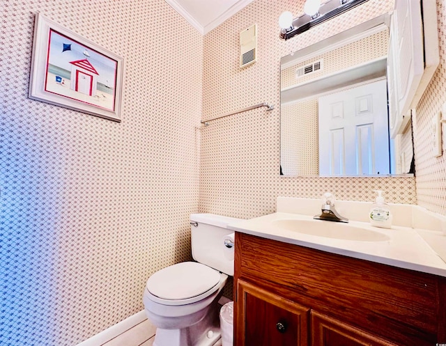 bathroom featuring ornamental molding, vanity, and toilet