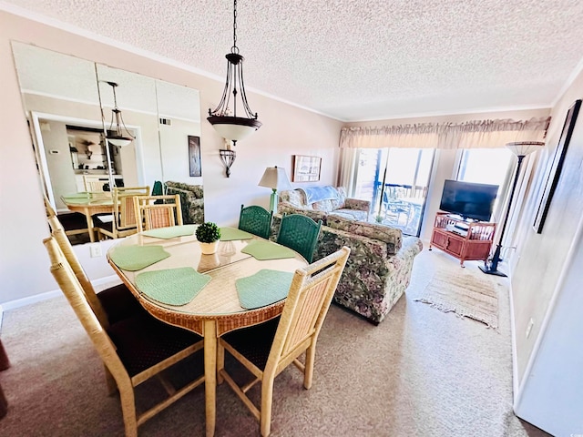 carpeted dining room featuring a textured ceiling and ornamental molding