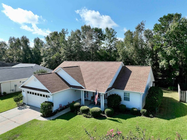 view of front of home with a front yard and a garage