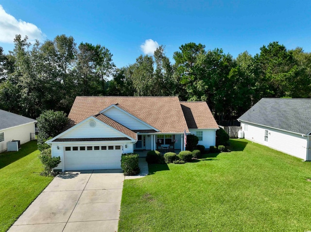 view of front of home with a front yard, central AC, covered porch, and a garage