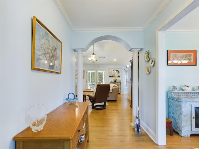 hall with ornamental molding, french doors, ornate columns, and light hardwood / wood-style floors